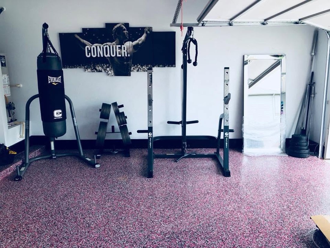 Home gym garage floor with pink and black flake epoxy