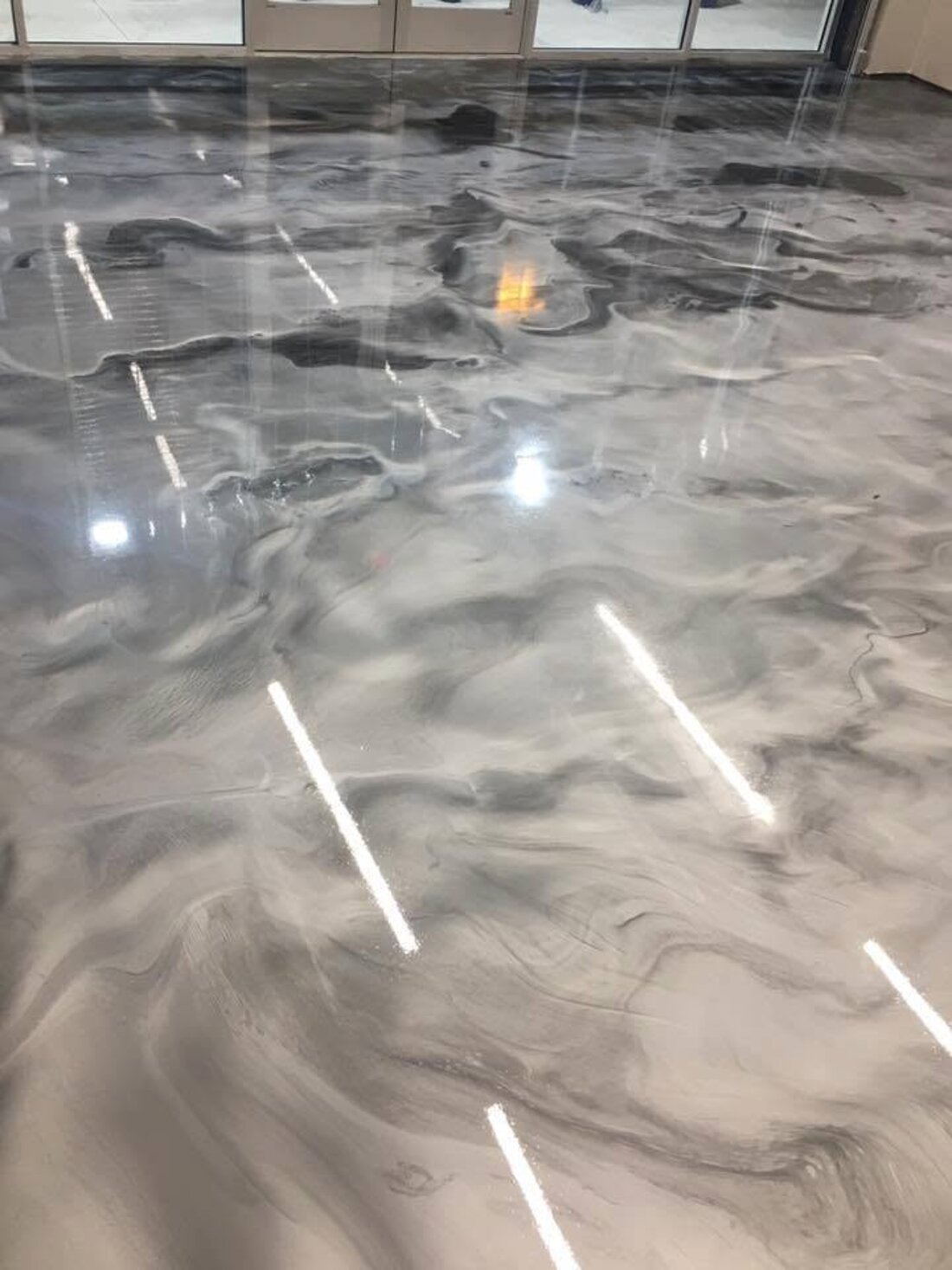 Commercial gray epoxy floor with white safety striping